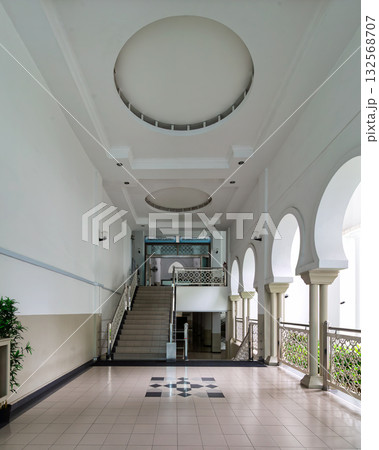 Interior architecture of Al-Bukhari Foundation Mosque, Kuala Lumpur, Malaysia, featuring staircase, arches, and ceiling details 132568707