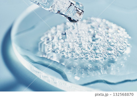 Close-up of clear Cosmetic liquid and bubbles on glass surface in laboratory setting 132568870