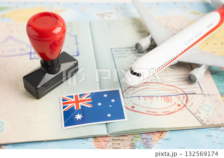 Approved Stamp visa and passport with Australia flag document to immigration at airport in country. Approved Stamp visa and passport with Australia flag document to immigration at airport in country. 132569174