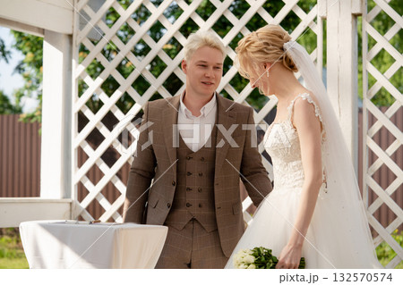 Wedding ceremony outdoors with couple enjoying each other's company Wedding ceremony outdoors with couple enjoying each other's company 132570574