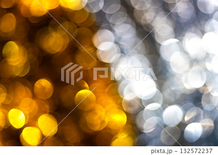 Golden and silver bokeh background with soft circular light reflections creating a luxurious and festive texture. Ideal for elegant holiday design, celebration, glamour photo, modern artistic concepts 132572237