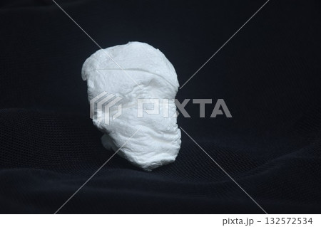 white tissue look like human face on black fabric background white tissue look like human face on black fabric background 132572534