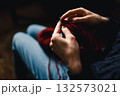 Cozy Knitting Session With Red Yarn: Hands Crafting A Warm Scarf For Relaxation And Home Comfort 132573021
