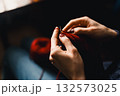 Cozy Knitting Session With Red Yarn: Hands Crafting A Warm Scarf For Relaxation And Home Comfort 132573025