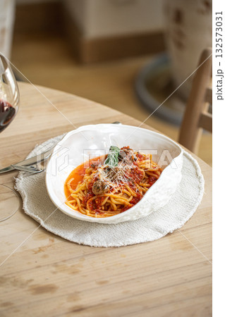 Spaghetti with meatballs in tomato sauce and cheese 132573031