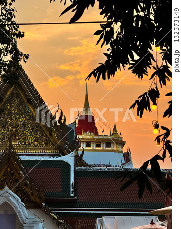 The Golden Mount Temple shines under a warm sunset sky in Bangkok reflecting peace faith and beauty of Thai culture. 132573149