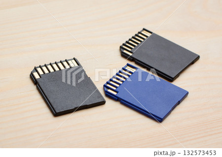 Modern fast SD memory cards on wooden table ready to use in different devices 132573453