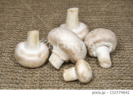 Champignon mushrooms on coarse cloth 132574642