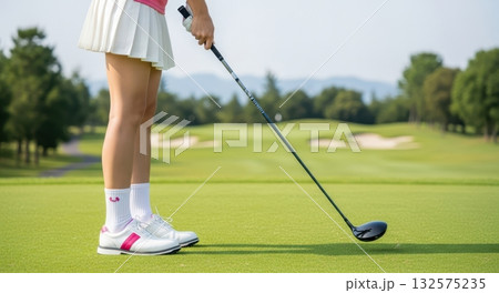 ティーグラウンドに立つ白のゴルフウェアの女性 ティーグラウンドに立つ白のゴルフウェアの女性 132575235