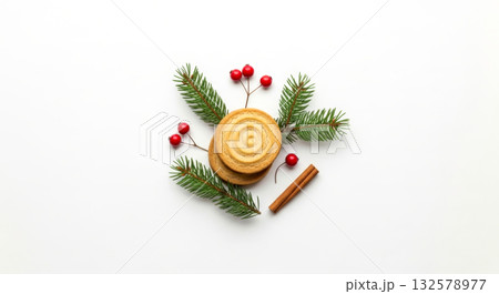 Christmas gingerbread cookies and spices with fir branches and berries on white table. 132578977