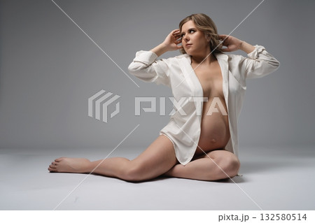 Pregnant Woman in White Shirt Posing 132580514