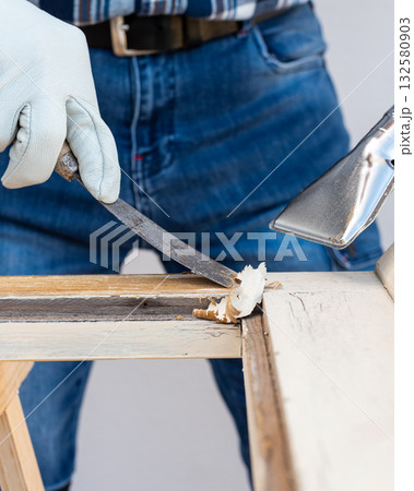 Carpenter at work, restoring an old wooden window. Carpentry. 132580903