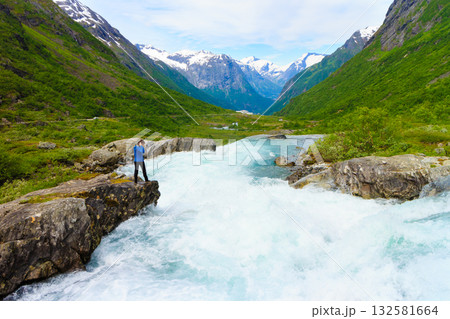 Tourist woman by Videfossen Waterfall in Norway 132581664