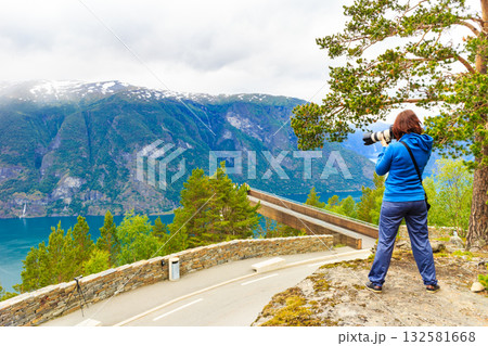 Tourist taking photo from Stegastein viewpoint Norway 132581668