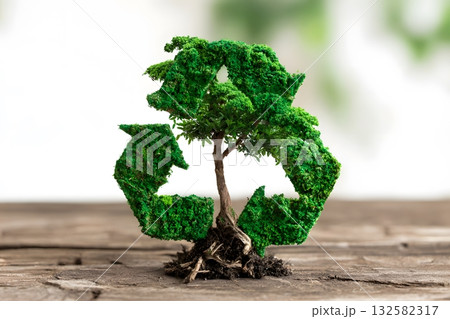 A green tree grows shaped like a recycling symbol. A green tree grows shaped like a recycling symbol. 132582317