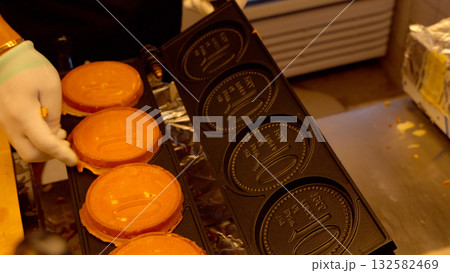 Hand baking Korean coin bread street food in Seoul Hand baking Korean coin bread street food in Seoul 132582469