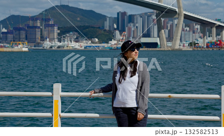 Woman enjoying scenic view of Busan Harbor Bridge 132582513
