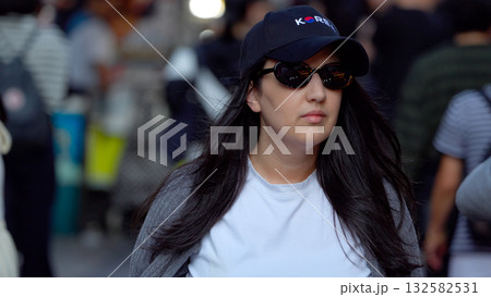 Woman wearing sunglasses and Korea cap in Seoul street Woman wearing sunglasses and Korea cap in Seoul street 132582531