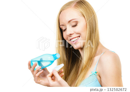 Woman cleaning her face skin with cotton pad 132582672