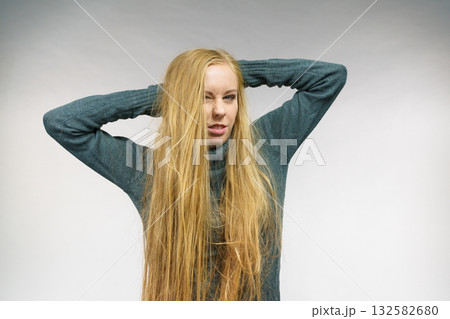 Displeased girl with messy long hair 132582680