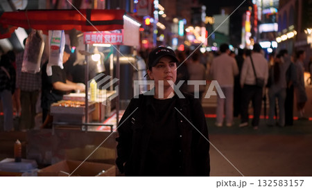 Woman exploring Seoul street food market at night Woman exploring Seoul street food market at night 132583157