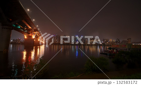 Seoul cityscape at night reflecting on Han River 132583172