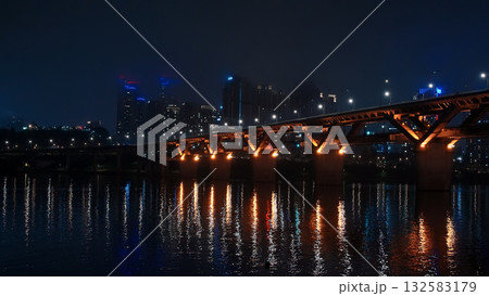 Seoul Han River bridge illuminating urban cityscape at night Seoul Han River bridge illuminating urban cityscape at night 132583179