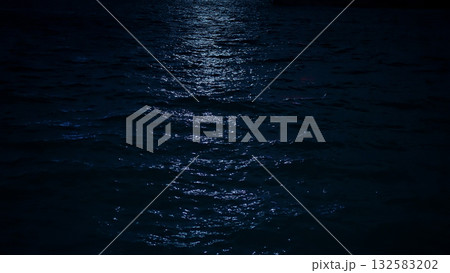 Moonlight reflecting on ocean ocean water surface at night 132583202
