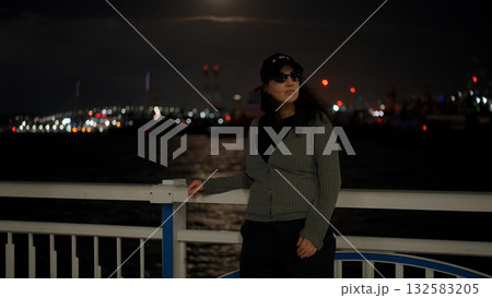 Woman enjoying night view of Busan city harbor lights Woman enjoying night view of Busan city harbor lights 132583205