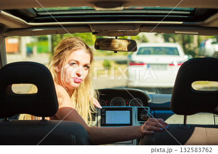 Woman in car looking back 132583762