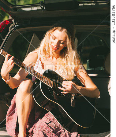 Girl with guitar on hatchback car Girl with guitar on hatchback car 132583766