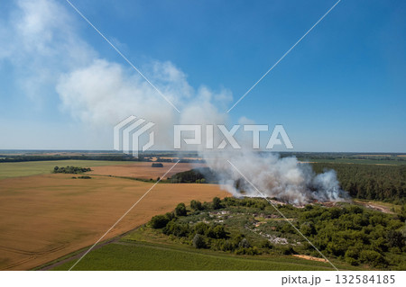 Aerial photo of rubbish dump in fire. Exhaling toxic gases from burning plastic, rubber and other types of garbage Aerial photo of rubbish dump in fire. Exhaling toxic gases from burning plastic, rubber and other types of garbage 132584185