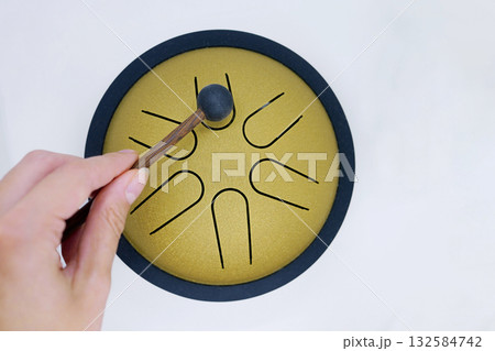 Hand Playing Tongue Drum with Mallet Hand Playing Tongue Drum with Mallet 132584742