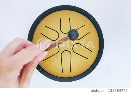 Hand Playing Tongue Drum with Mallet Hand Playing Tongue Drum with Mallet 132584743