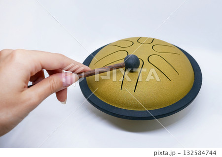 Hand Playing Tongue Drum with Mallet Hand Playing Tongue Drum with Mallet 132584744