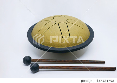Golden Tongue Drum with Wooden Mallets on White Background Golden Tongue Drum with Wooden Mallets on White Background 132584758