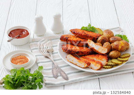 Paprika-Rubbed Pork Chops on plate with potatoes 132584840