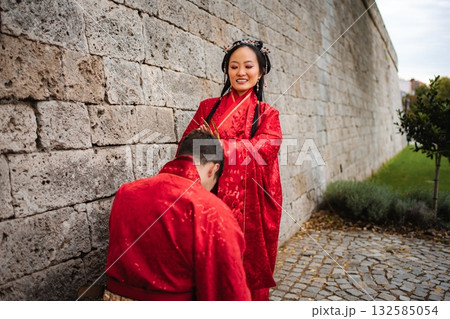 Interracial couple celebrating Chinese wedding ceremony tradition Interracial couple celebrating Chinese wedding ceremony tradition 132585054