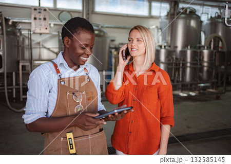 Women entrepreneurs making a phone call, managing brewery business Women entrepreneurs making a phone call, managing brewery business 132585145