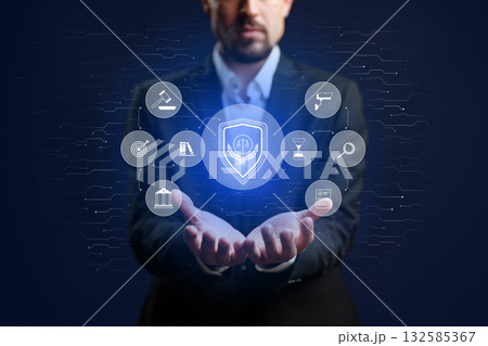 Man in suit holds glowing shield with legal icons in hands, representing protection and justice Man in suit holds glowing shield with legal icons in hands, representing protection and justice 132585367