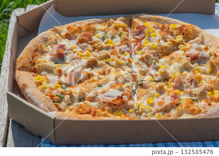 Pizza in a box. Food delivery. Pizza with chicken, bacon, corn. 132585476