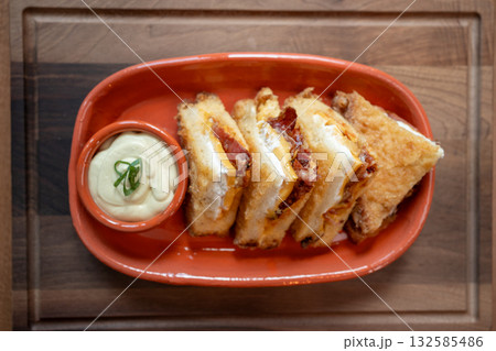 Deliciously crafted grilled cheese with decadent dipping sauce awaits enjoyment Deliciously crafted grilled cheese with decadent dipping sauce awaits enjoyment 132585486