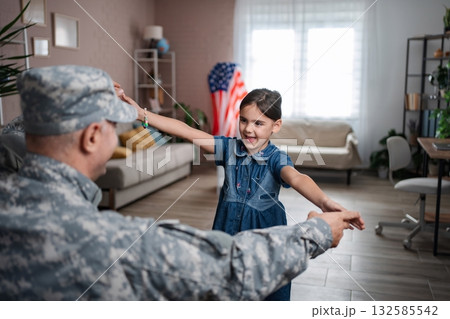 Soldier father is dancing with his daughter at home 132585542