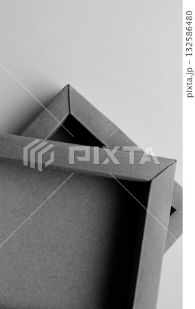 Square Cardboard Boxes One on Another on a White Surface Vertical Monochrome Photo. Same Craft Souvenir Boxes Isolated on White  132586480
