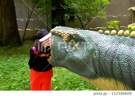 Good leisure for a child. Teaching a child through play. A handsome boy 3 oldl in a yellow jacket excavates the remains of dinosaurs. High quality photo. Good leisure for a child. Teaching a child through play. A handsome boy 3 oldl in a yellow jacket excavates the remains of dinosaurs. High quality photo. 132586609