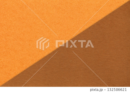 Textured craft orange and brown paper background, half two colors. Vintage tan cardboard with copy space Textured craft orange and brown paper background, half two colors. Vintage tan cardboard with copy space 132586621