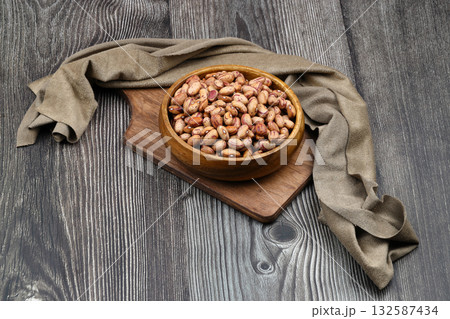 red kidney beans in wooden bowl isolated on dark background. 132587434