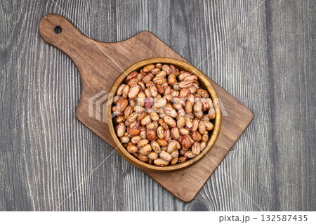 red kidney beans in wooden bowl isolated on dark background. 132587435