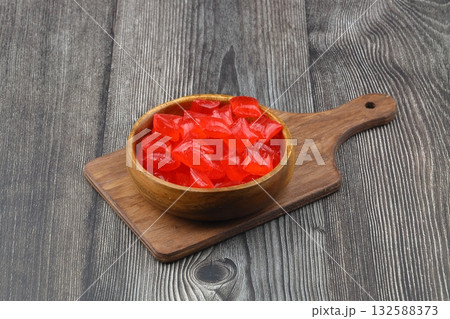 Red sugar in a wooden bowl on a wooden background. Ramadan Feast candy. 132588373