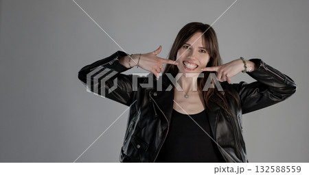 Happy rocker woman pointing her smile with fingers 132588559